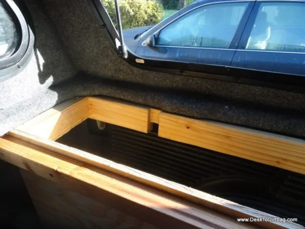 How the vertical side bins are attached to the truck--precisely notched out 2x4 where the canopy clamp goes.