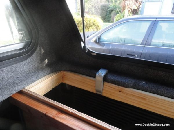 How the vertical side bins are attached to the truck--canopy clamp attached.