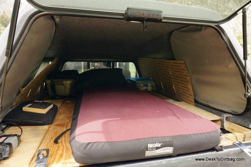My sleep setup in the elevated position--things can be moved into the cab or positioned along side the mattress.