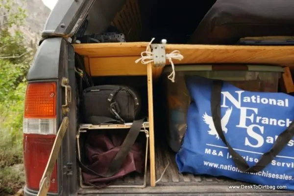 A view under the platform and left hand table. I kept my electronics securely stashed under the table. The blue bag is a my kitchen supply--don't use a box, kitchen stuff is pokey and strange shaped, a bag is better.