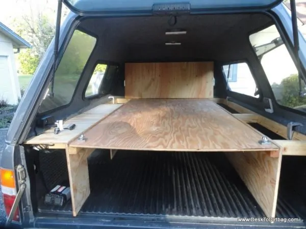 The large plywood board can be placed in the upper position for gear storage below and sleeping above. Tip: you don't need to lift up the back shelf to slide it into place. That was just for demonstration.