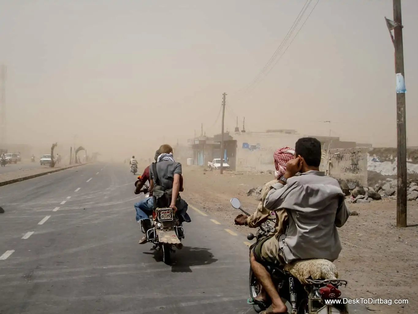 Riding into a sandstorm by motorbike in Mocha, Yemen.