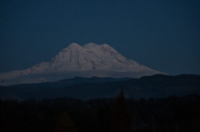 The three peaks of Mount Rainier viewed from the west - Conquering Debt Mountain