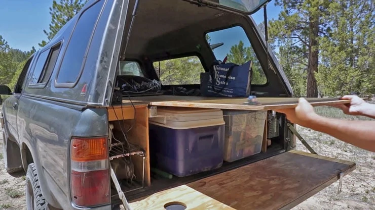 Removing the truck bed sleeping platform from the upper position