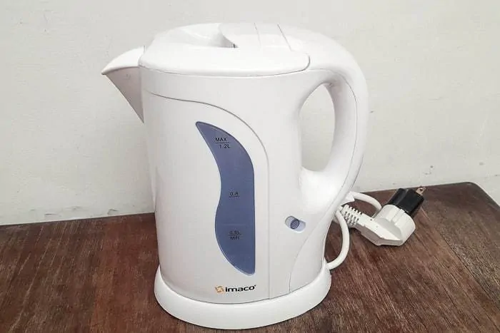 Having a water kettle is a trick for how to make a hotel room feel cozy and more like home.