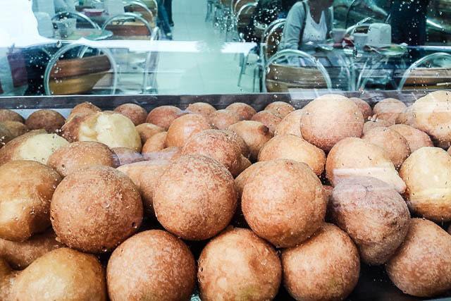 Stacks of delicious bunuelos - What to Eat in Colombia, a Guide to Colombian Food