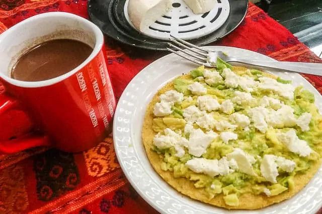 Nescafe and an arepa with cheese and avocado - What to Eat in Colombia, a Guide to Colombian Food