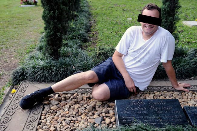 Some gringo posing all happy at the grave of Pablo Escobar