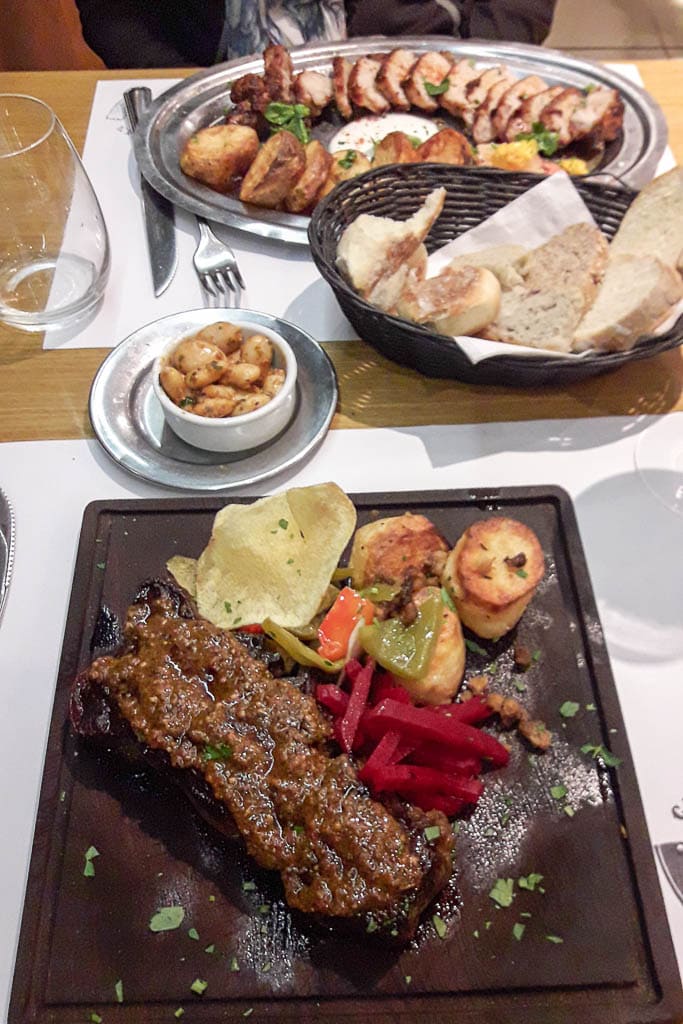 Bife de chorizo steak with chimichurri, glass of malbec not pictured - The Top 18 Things to Do in Buenos Aires