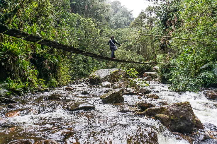 Crossing slick old swinging bridges is one reason why you might want travel insurance for Colombia