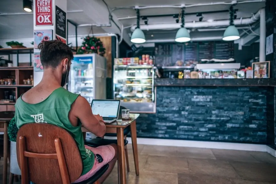 Working on a laptop at a coffee shop - How to Find the Best Travel VPN