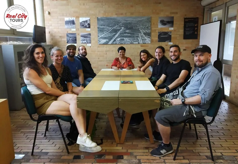 Meeting with social leaders on the Barrio Transformation tour in Moravia Medellin. These Moravia social tours are a great way to interact with locals and learn about their efforts.