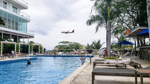 Plane passing in front of the pool at the resort
