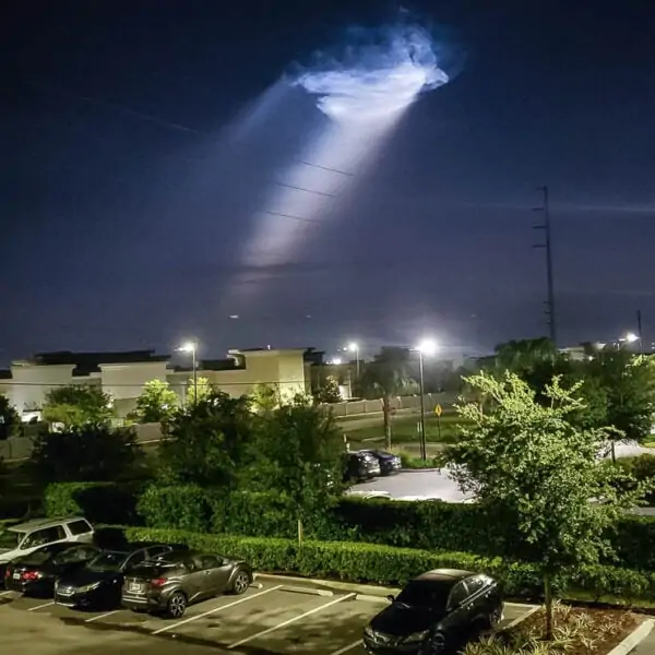 The plume of a pre-dawn Falcon 9 launch